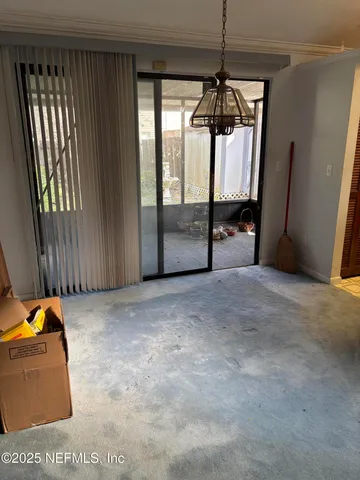 a view of a room with furniture and a window