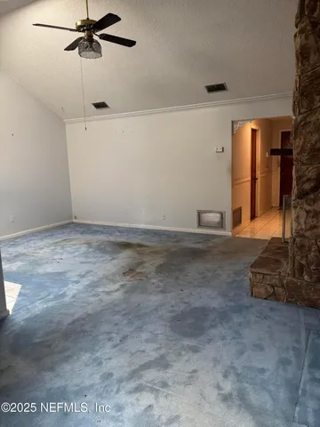 a view of a room with furniture and a window