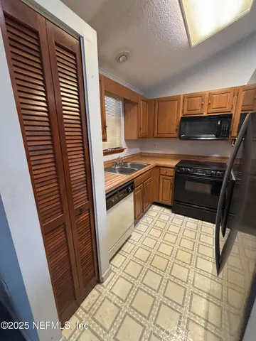 a kitchen with sink and cabinets