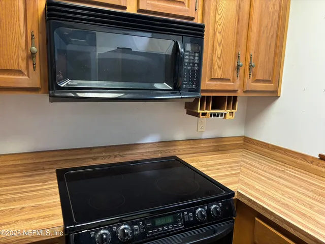 a stove top oven sitting inside of a kitchen