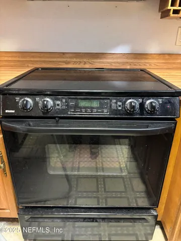 a stove top oven sitting inside of a kitchen