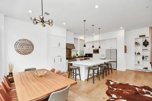 a large kitchen with a table and chairs