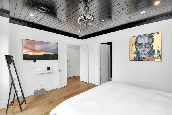 a bedroom with a bed and a flat screen tv