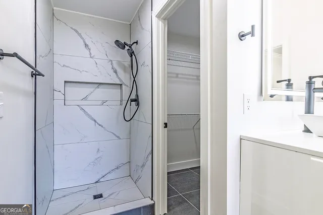 a bathroom with a glass shower door