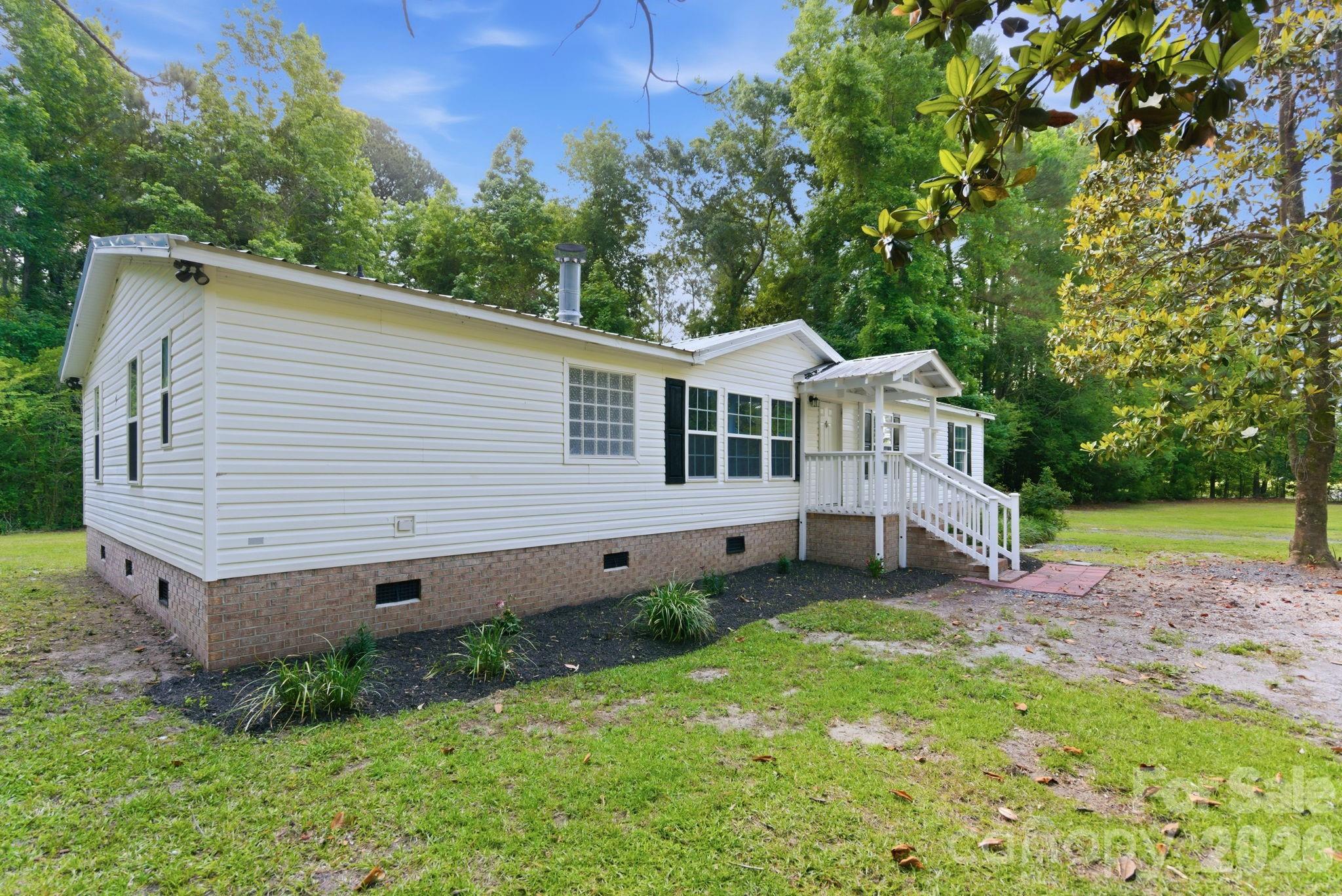 481 Harrell Road Burgaw, NC 28425 - Photo 19 of 25 a view of a house with a yard and sitting area