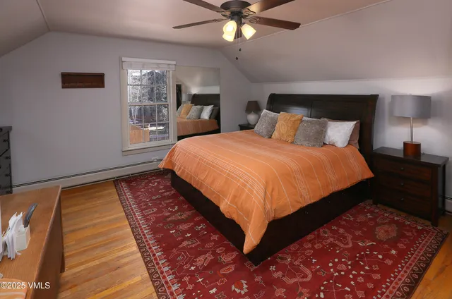 a bedroom with furniture and a window