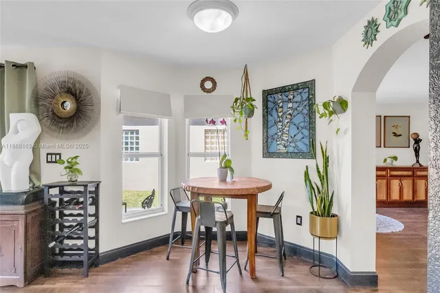 a view of a dining room with furniture and wooden floor