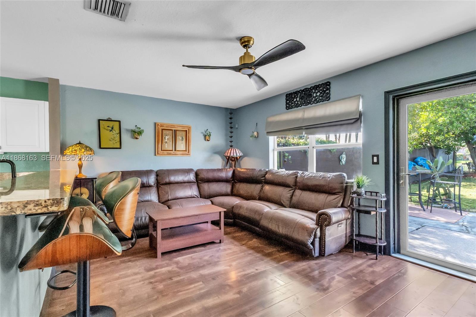 12160 Southwest 135th Terrace Miami, FL 33186 - Photo 14 of 46 a living room with furniture and a large window