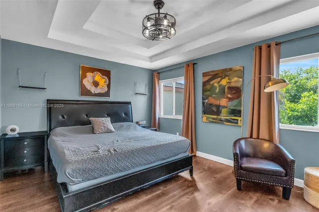 a bedroom with a bed and a chandelier