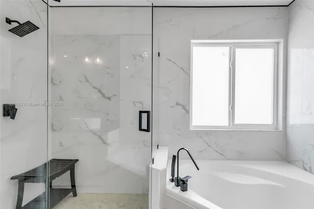 a bathroom with a bathtub and shower