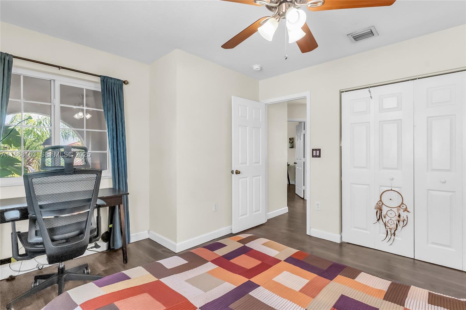 12160 Southwest 135th Terrace Miami, FL 33186 - Photo 27 of 46 a bedroom with a bed and a chandelier