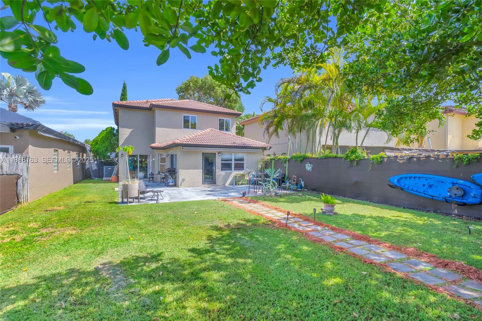 12160 Southwest 135th Terrace Miami, FL 33186 - Photo 30 of 46 a front view of a house with garden