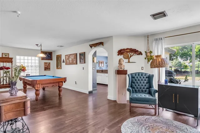 a living room with furniture and wooden floor