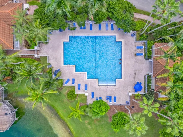 an aerial view of a house with a yard basket ball court and outdoor seating