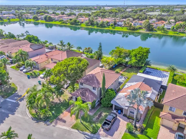 an aerial view of lake and residential houses with outdoor space
