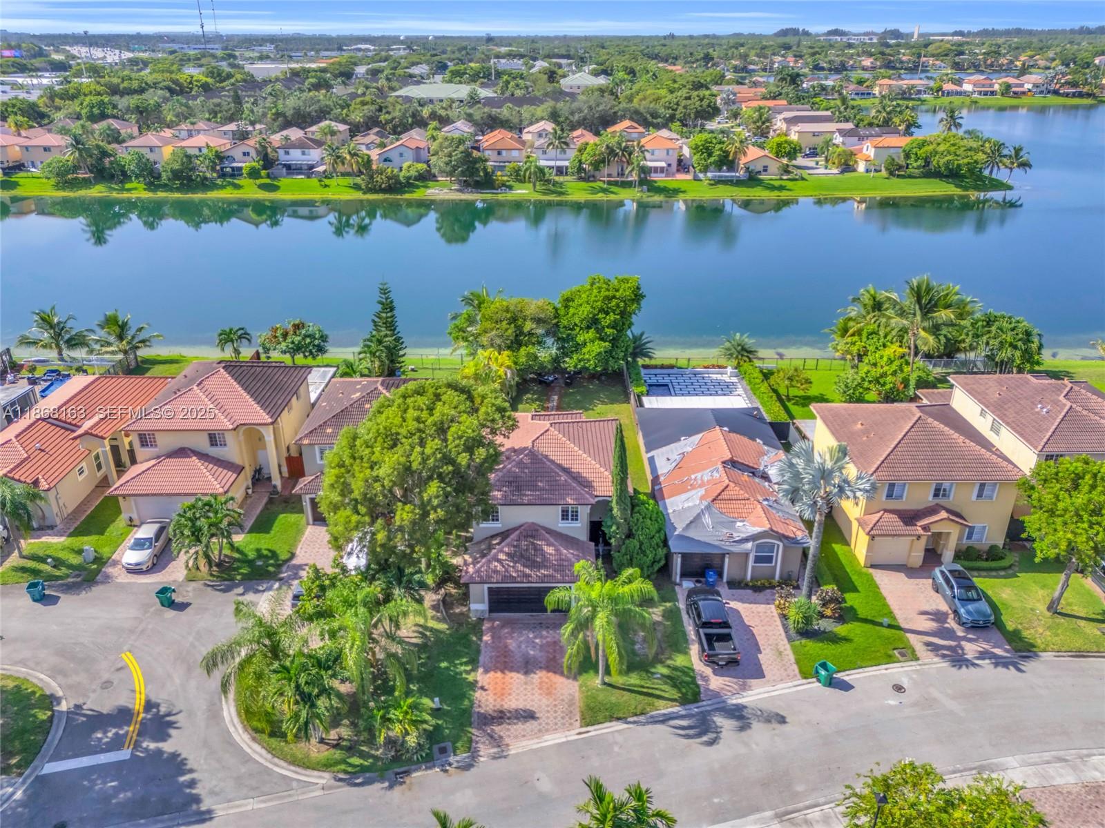 12160 Southwest 135th Terrace Miami, FL 33186 - Photo 40 of 46 an aerial view of lake and residential houses with outdoor space