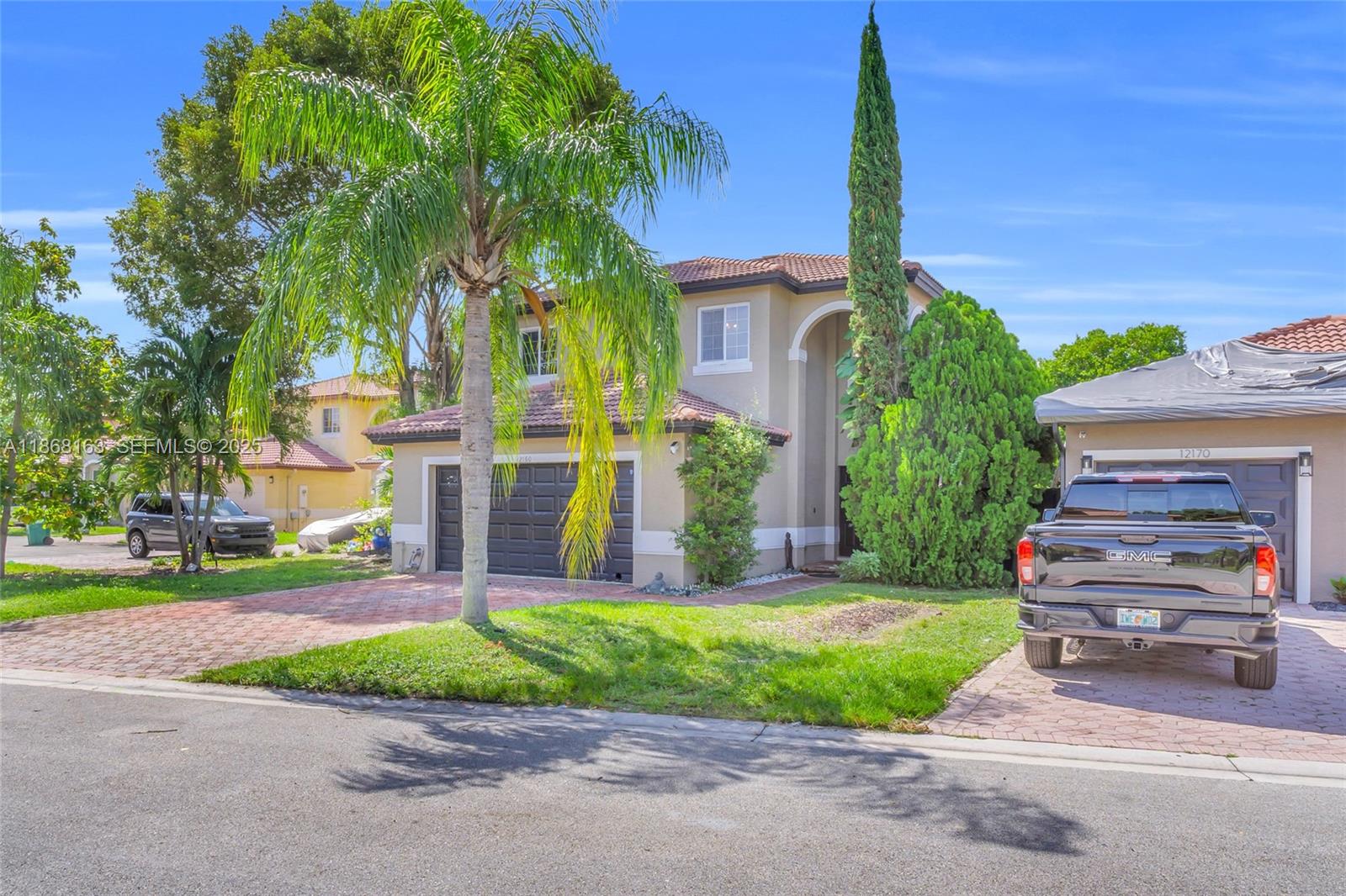 12160 Southwest 135th Terrace Miami, FL 33186 - Photo 42 of 46 a front view of a house with a garden and trees
