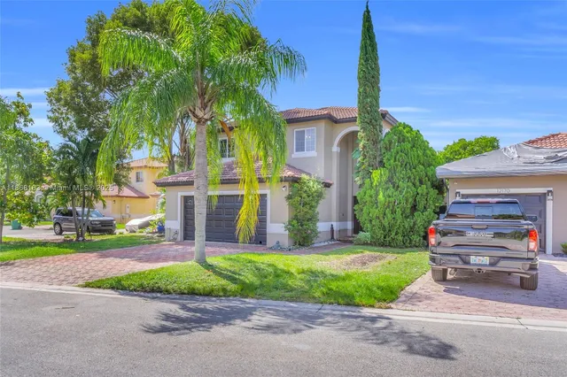 a front view of house with yard and green space