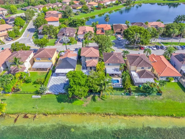 an aerial view of multiple houses with yard