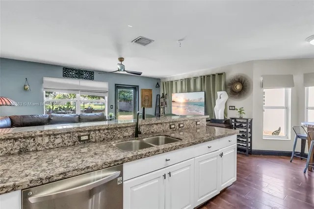 a kitchen with counter top space and windows