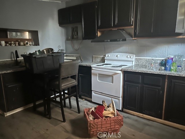 3483 Skylane Drive Riverside, CA 92509 - Photo 11 of 15 a kitchen with stainless steel appliances granite countertop a table chairs sink and cabinets