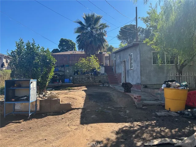 a view of a backyard with plants and trees