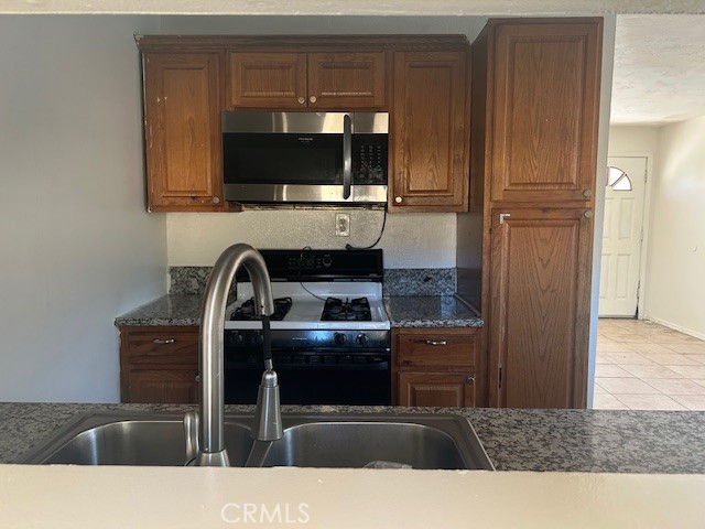 3483 Skylane Drive Riverside, CA 92509 - Photo 4 of 15 a kitchen with a sink and a refrigerator