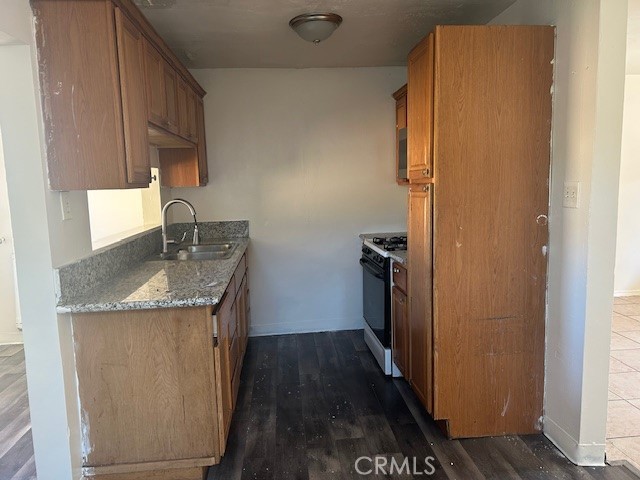 3483 Skylane Drive Riverside, CA 92509 - Photo 9 of 15 a kitchen with a granite countertop sink stove and refrigerator