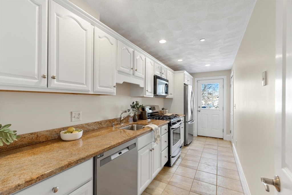 8 Common Street, Unit 3 Stoneham, MA 02180 - Photo 1 of 29 a kitchen with stainless steel appliances granite countertop a sink stove and cabinets