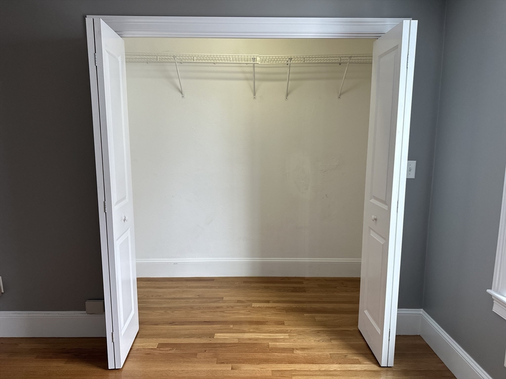 8 Common Street, Unit 3 Stoneham, MA 02180 - Photo 16 of 29 a view of room with wooden floor