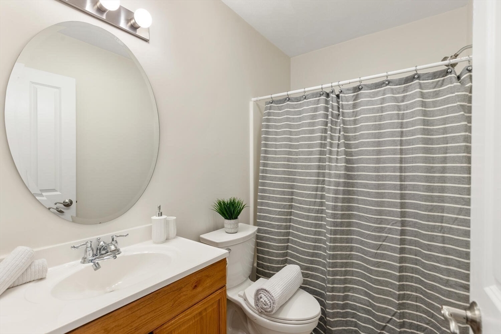 8 Common Street, Unit 3 Stoneham, MA 02180 - Photo 17 of 29 a bathroom with a sink a toilet and mirror