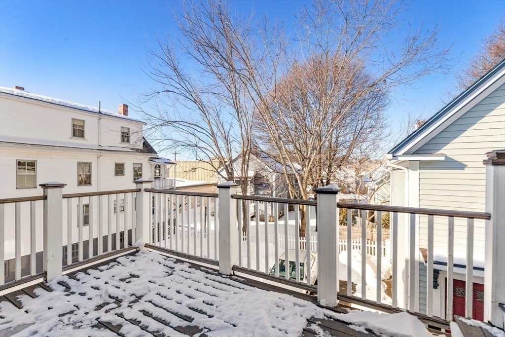8 Common Street, Unit 3 Stoneham, MA 02180 - Photo 20 of 29 a porch with a bench in front of house