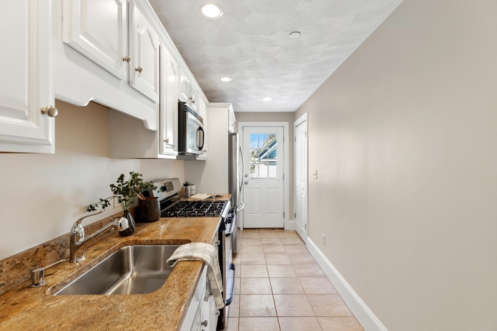 8 Common Street, Unit 3 Stoneham, MA 02180 - Photo 2 of 29 a kitchen with a sink and cabinets
