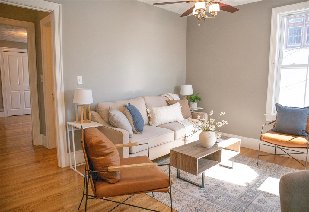 8 Common Street, Unit 3 Stoneham, MA 02180 - Photo 5 of 29 a living room with furniture and wooden floor