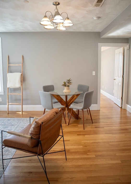 8 Common Street, Unit 3 Stoneham, MA 02180 - Photo 7 of 29 a view of a dining room with furniture and wooden floor