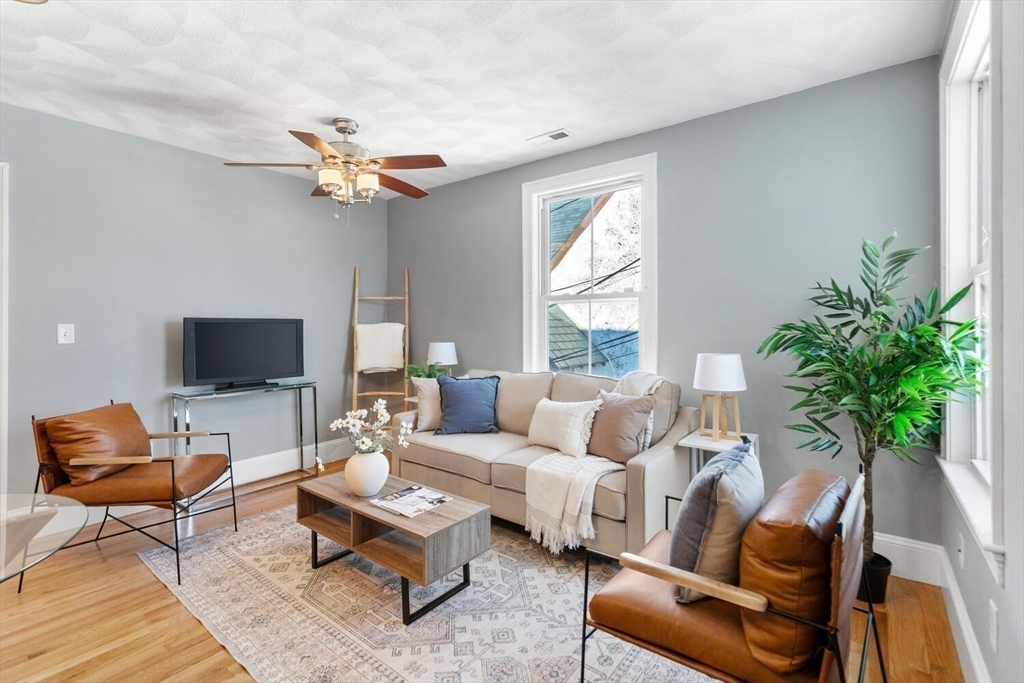 8 Common Street, Unit 3 Stoneham, MA 02180 - Photo 9 of 29 a living room with furniture potted plant and a window