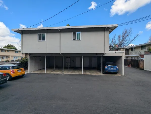 a view of a car park in front of house