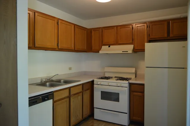 a kitchen with a sink stove and refrigerator