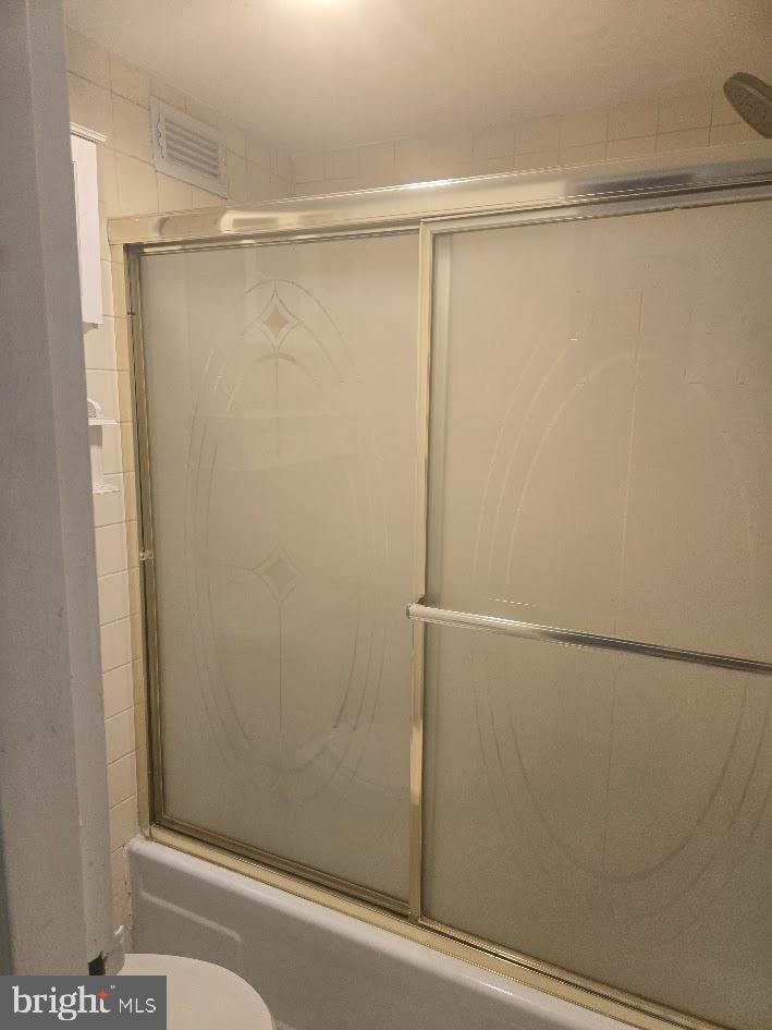 1836 Metzerott Road, Unit 1606 Hyattsville, MD 20783 - Photo 12 of 18 a bathroom with a glass shower door