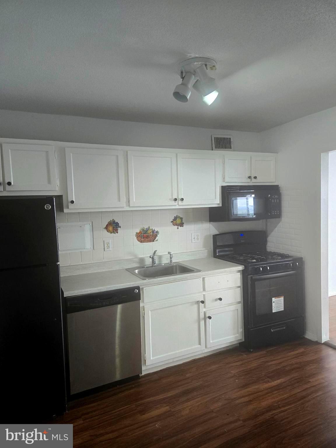 1836 Metzerott Road, Unit 1606 Hyattsville, MD 20783 - Photo 6 of 18 a kitchen with granite countertop a sink and cabinets