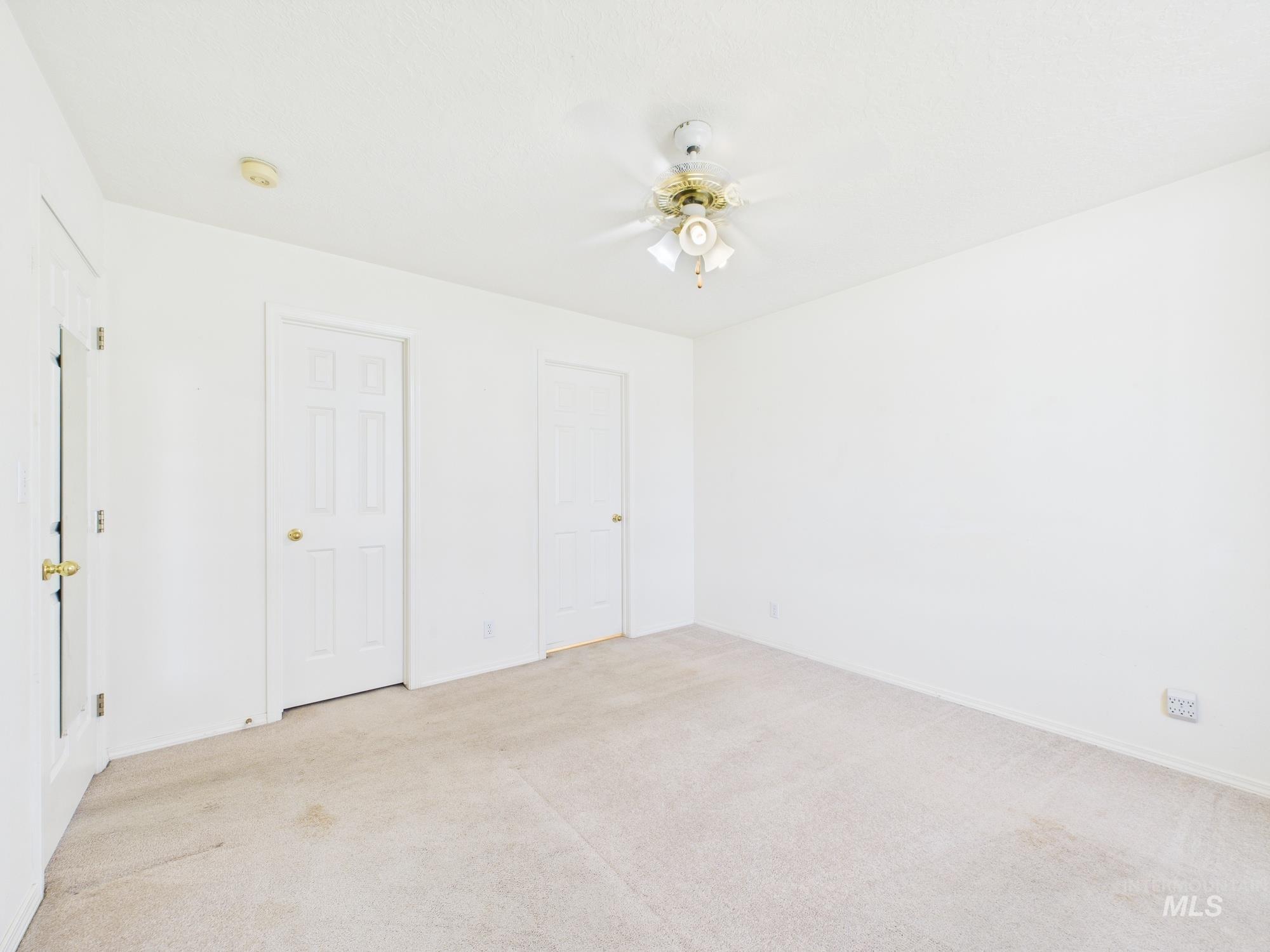 1786 North Plaza Road Emmett, ID 83617 - Photo 11 of 36 Unfurnished bedroom with light carpet and ceiling fan