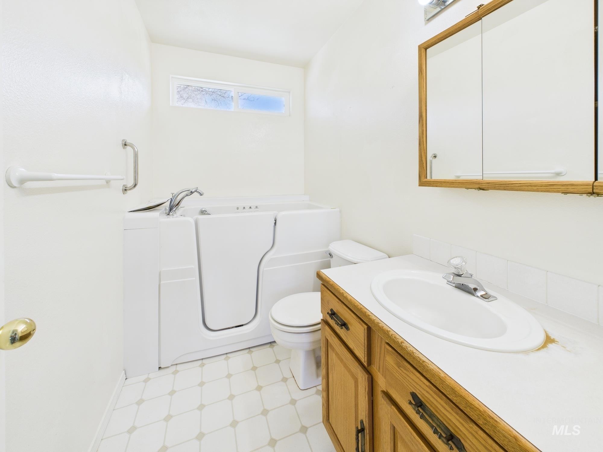 1786 North Plaza Road Emmett, ID 83617 - Photo 13 of 36 Bathroom featuring light floors, vanity, and a garden tub