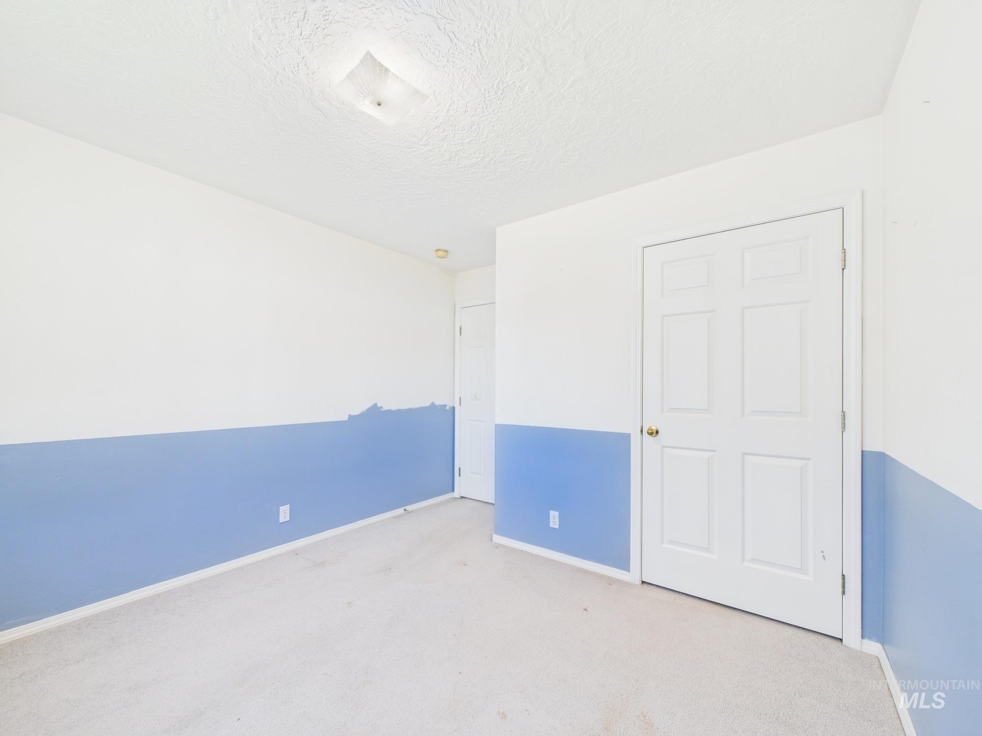 1786 North Plaza Road Emmett, ID 83617 - Photo 16 of 36 Unfurnished bedroom with carpet flooring and a textured ceiling