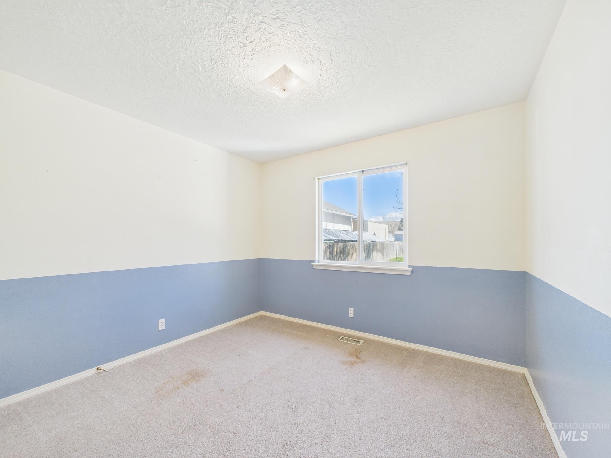 1786 North Plaza Road Emmett, ID 83617 - Photo 17 of 36 Carpeted empty room with a textured ceiling and baseboards