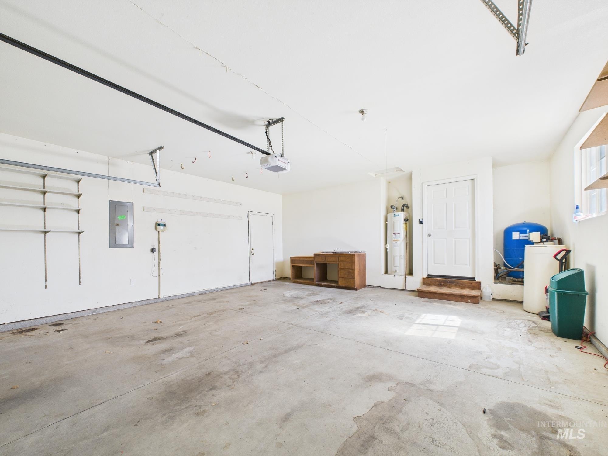 1786 North Plaza Road Emmett, ID 83617 - Photo 23 of 36 Garage with electric panel, electric water heater, and a garage door opener
