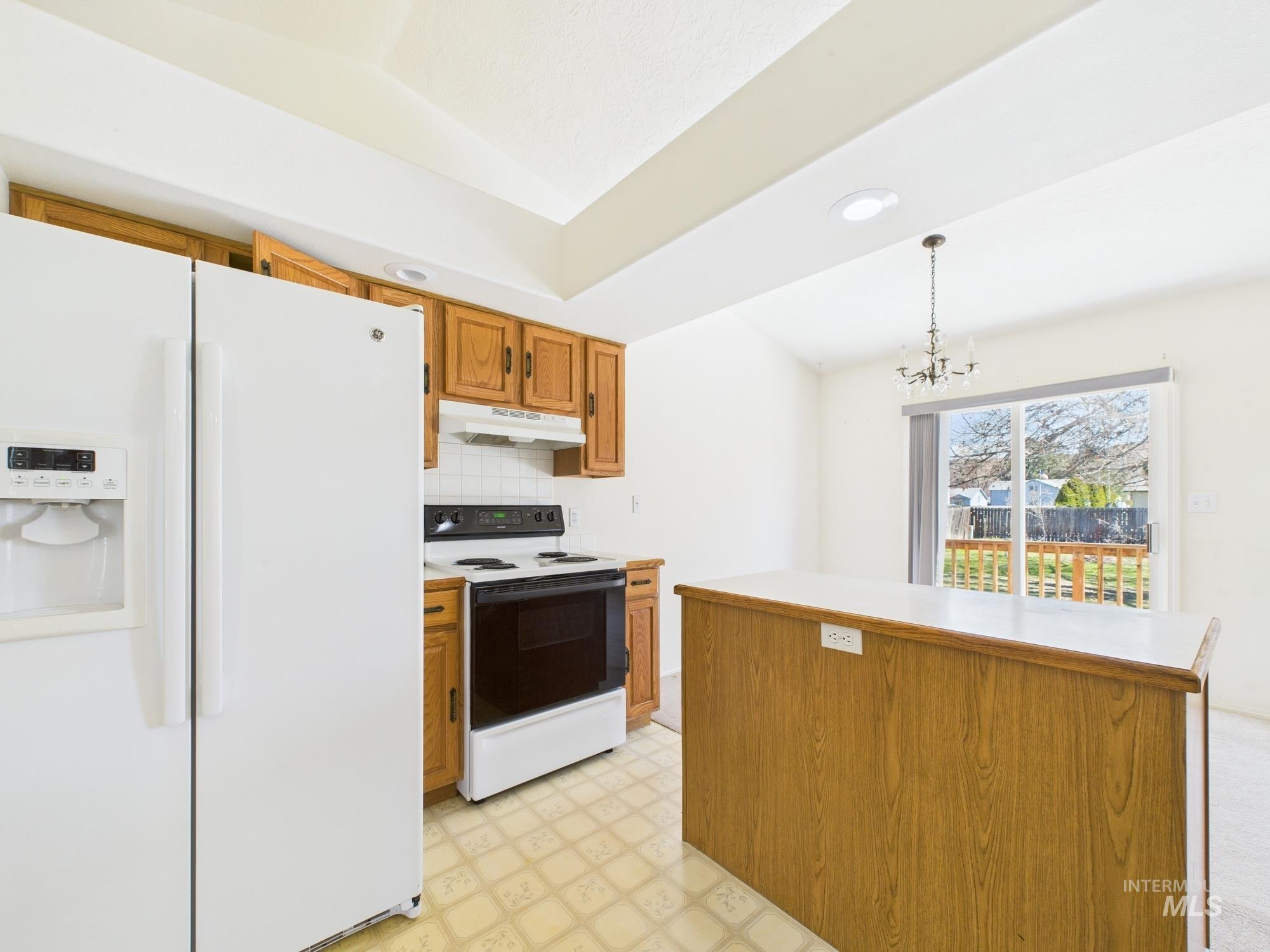 1786 North Plaza Road Emmett, ID 83617 - Photo 8 of 36 Kitchen featuring light floors, white appliances, brown cabinets, light countertops, and recessed lighting