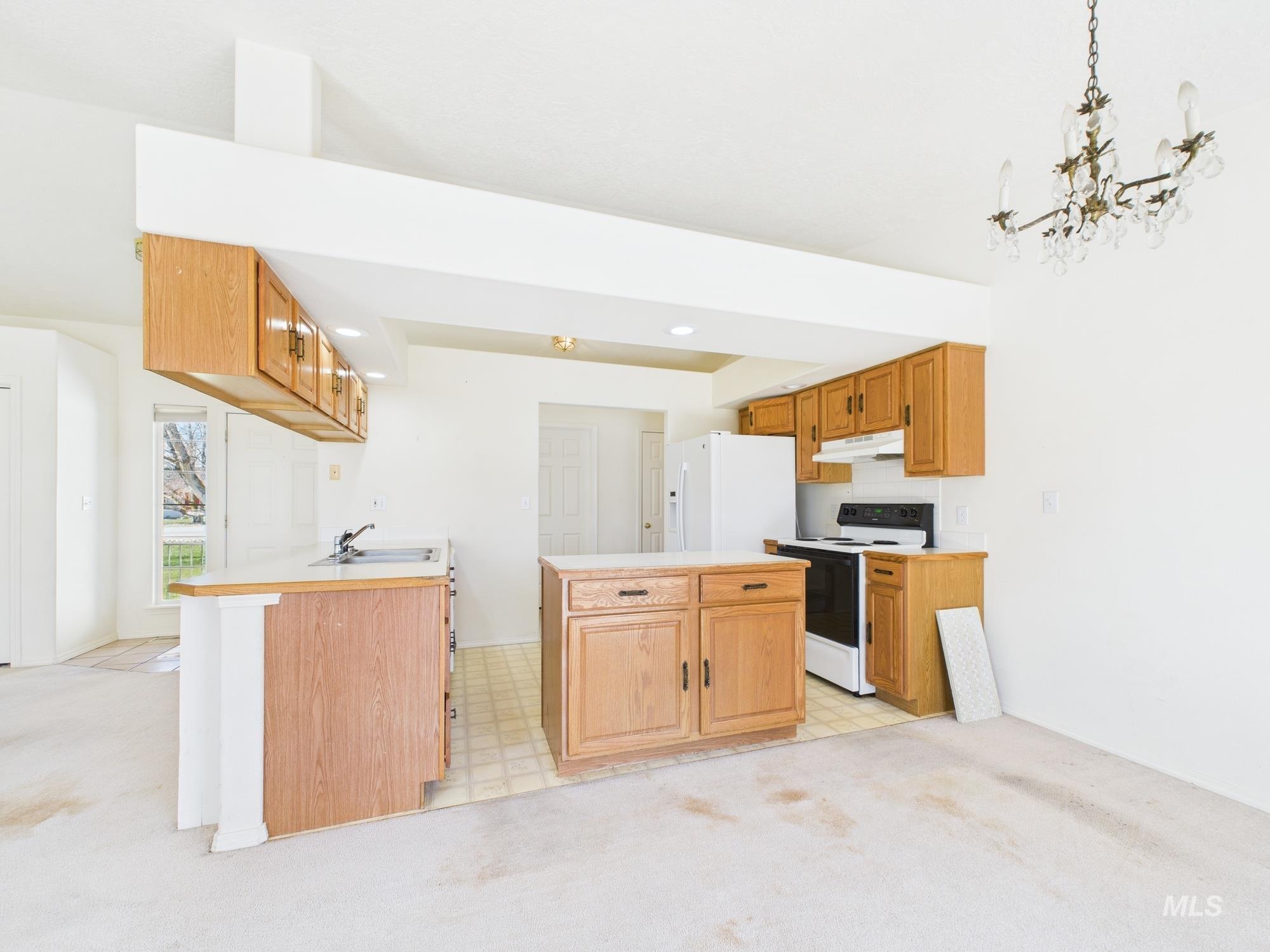 1786 North Plaza Road Emmett, ID 83617 - Photo 9 of 36 Kitchen with light colored carpet, white appliances, light countertops, decorative light fixtures, and recessed lighting