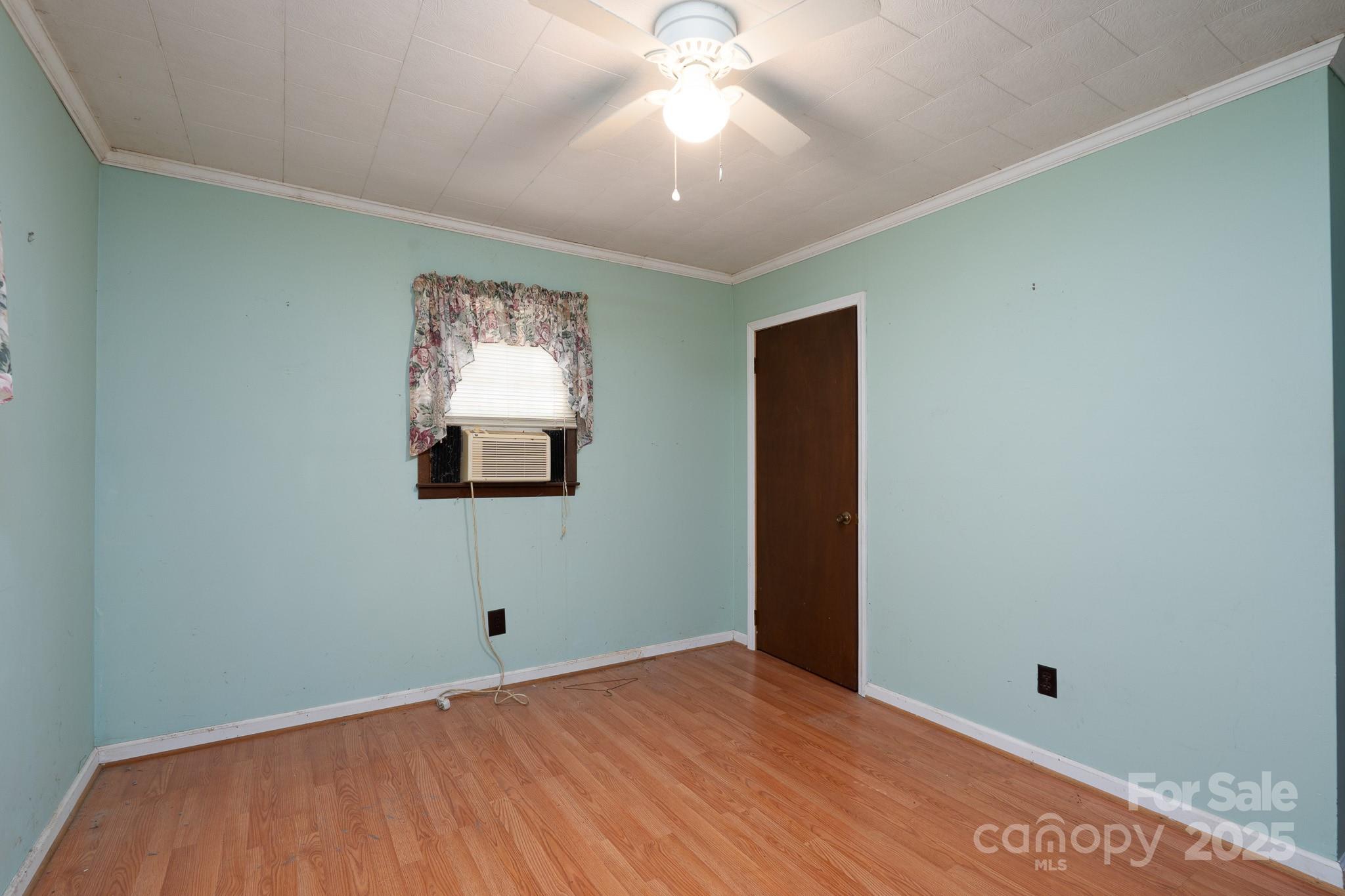 335 Richfield Road Richfield, NC 28137 - Photo 12 of 33 a view of an empty room with window and wooden floor