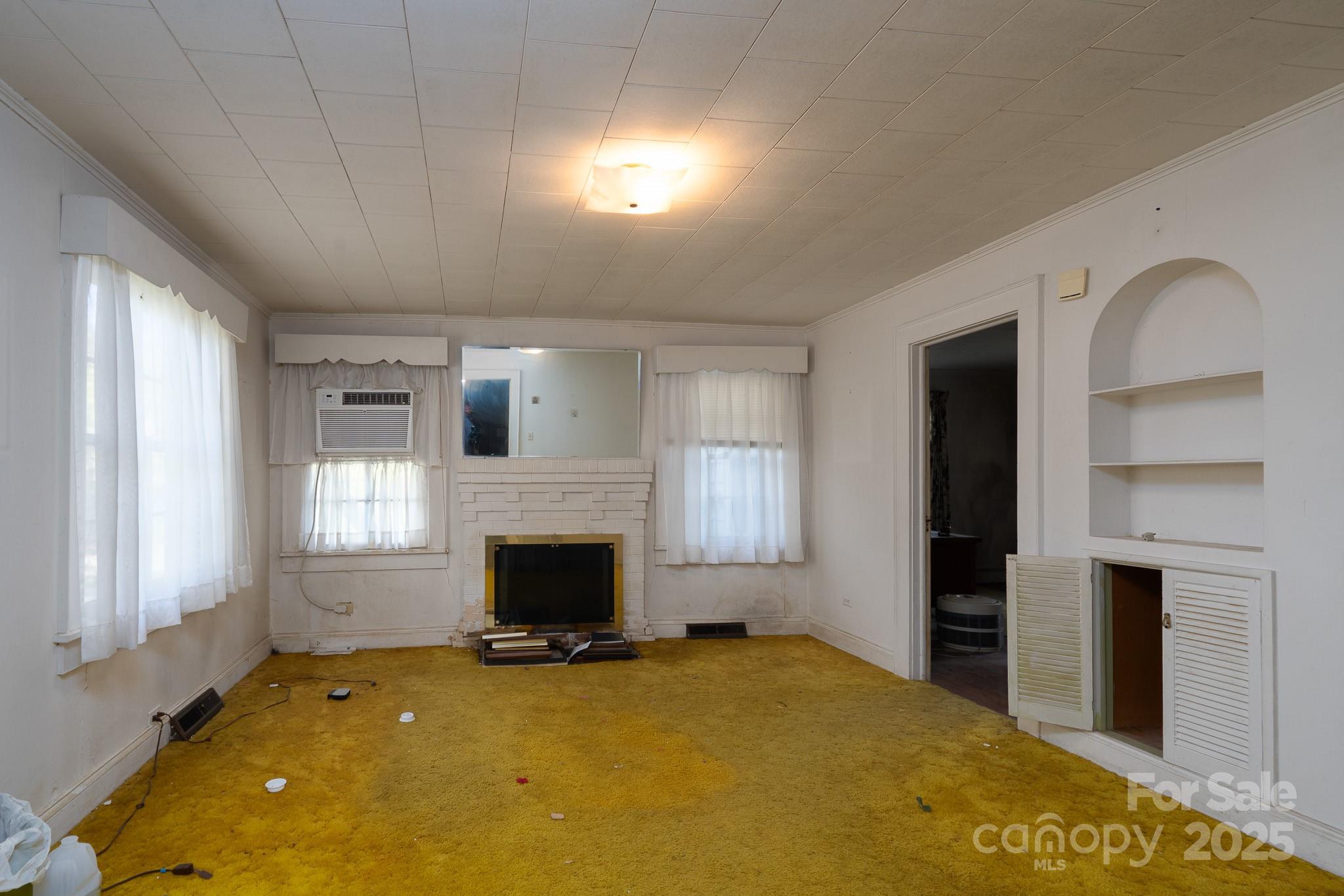 335 Richfield Road Richfield, NC 28137 - Photo 5 of 33 a view of an empty room with a fireplace and a window