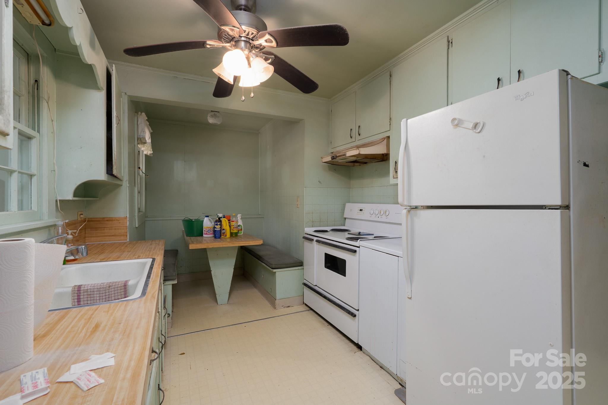 335 Richfield Road Richfield, NC 28137 - Photo 8 of 33 a white kitchen with a refrigerator a stove a sink and dishwasher